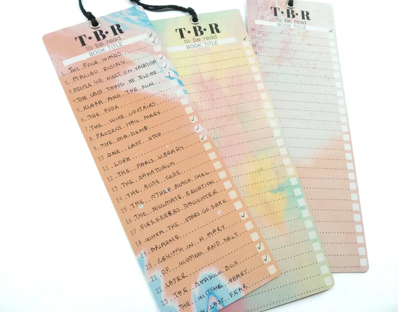 Image of three bookmarks in rainbow colors. They say "TBR" at the top with  lines for listing books. 