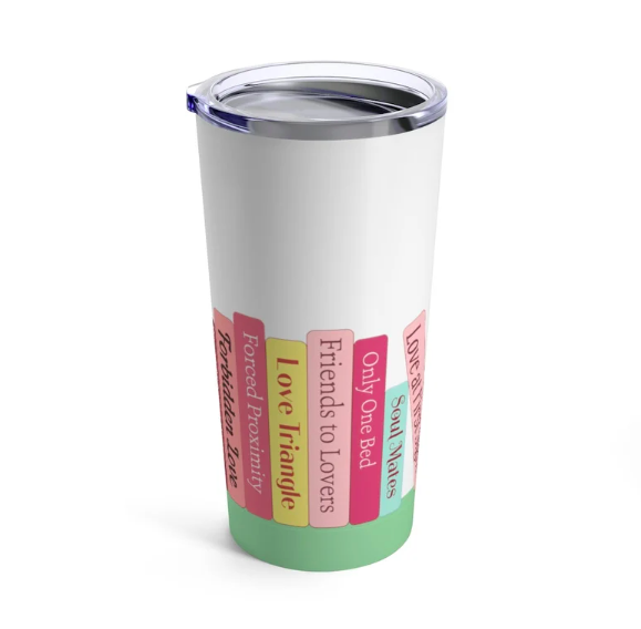 White insulated tumbler with pastel colored illustrations of books listing romance tropes (like love triangles, friends to lovers, only one bed) listed on spines