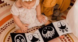 baby witting with cloth book