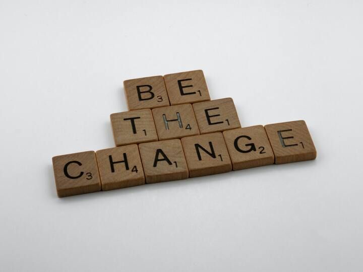 Image of scrabble tiles that spell out "be the change."