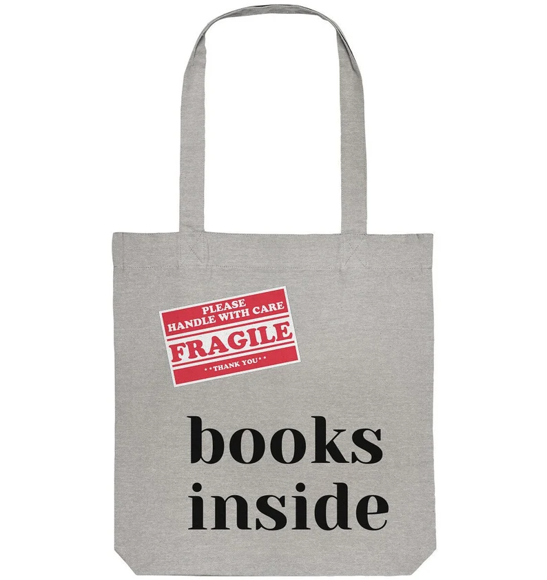 Image of a grey canvas tote. It has a red label on it that reads 