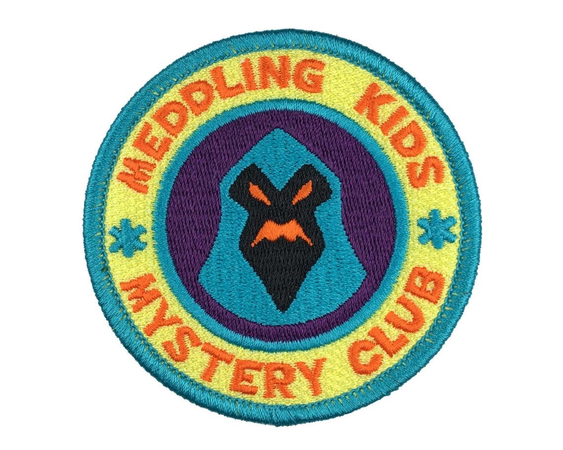 photo of Scooby Doo themed patch, reads "Meddling Kids Mystery Club"
