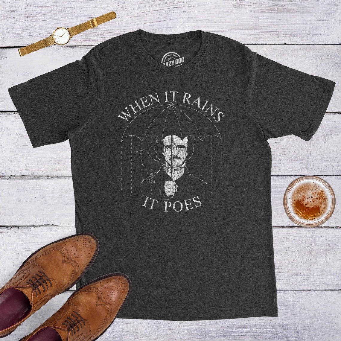 photo of Edgar Allan Poe shirt where he is holding an umbrella that says 