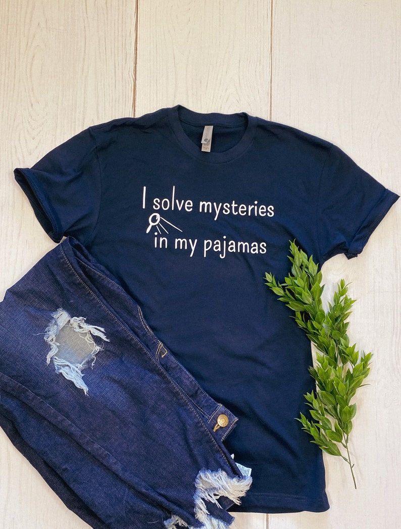 photo of blue t-shirt that reads "I solve mysteries in my pajamas"