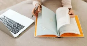 image of a laptop with a book