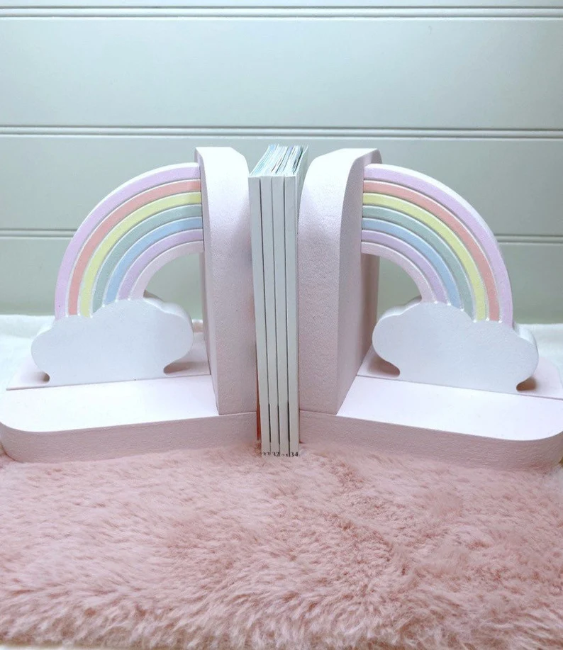 Image of two pastel rainbow bookends on a pink rug.