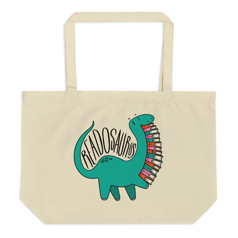 Image of a large tote featuring a green dinosaur holding books. It says 