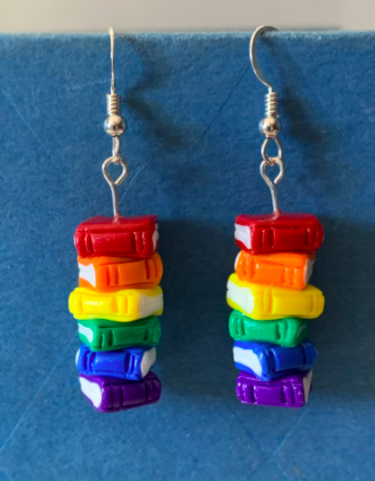 Two dangling earrings of mini rainbow book stacks