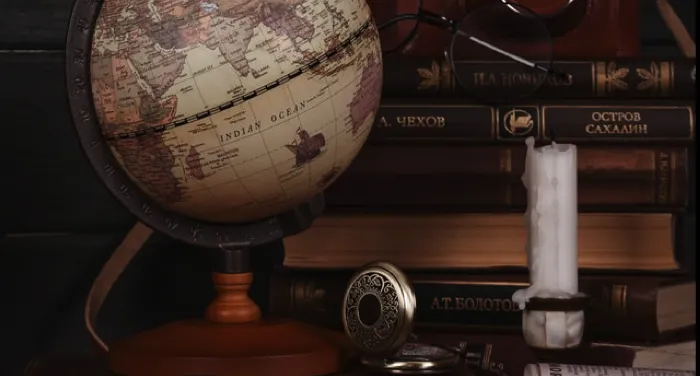 antique looking set up with globe, books, etc.