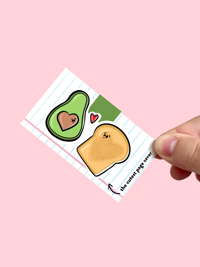 Image of two magnetic bookmarks. One is an avocado and one is a piece of toast. 
