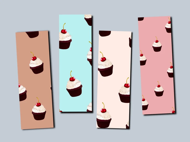 Image of four bookmarks in brown, blue, peach, and pink, all featuring cupcakes.