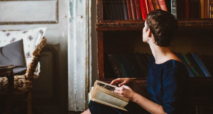 image of a person looking at a bookshelf