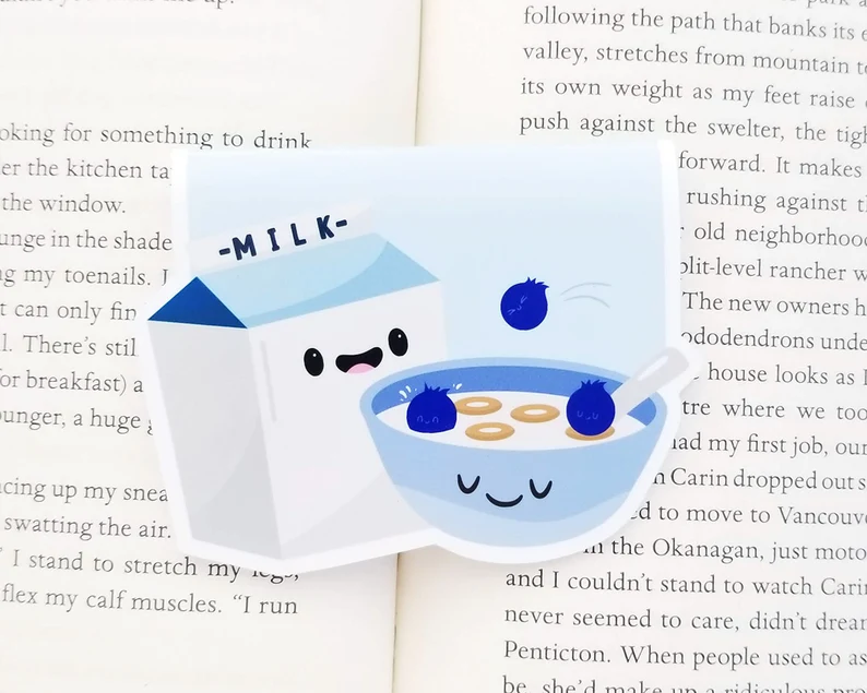 Image of a magnetic bookmark in blue and white. The image is of a carton of milk and bowl of cereal.