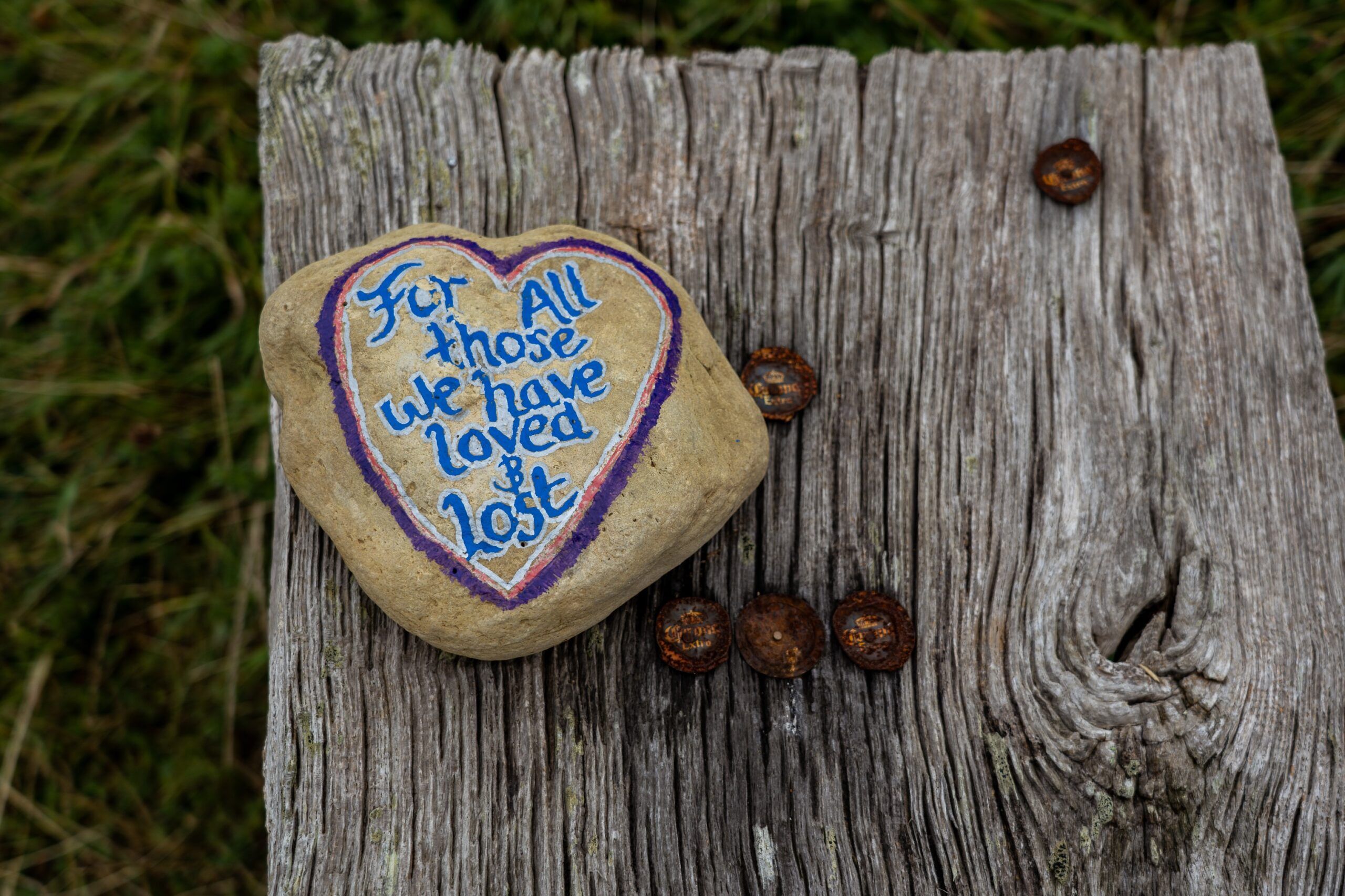 A pebble painted with the words: "For all those who have loved and lost"