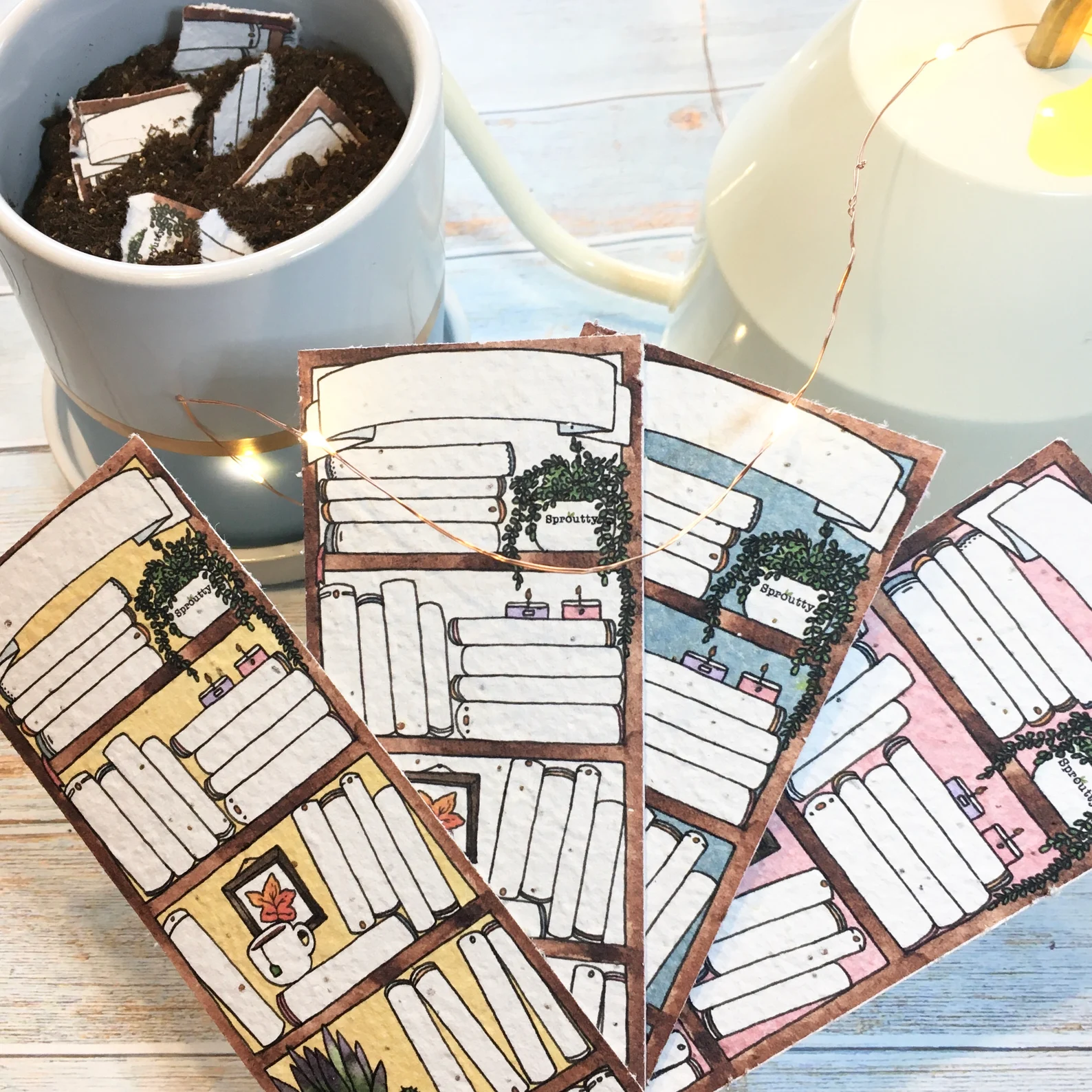 Four bookmarks illustrated with bookshelves stacked with books with blank spines and small plants. Behind the bookmarks sits a small planter filled with soil and a torn up bookmark.