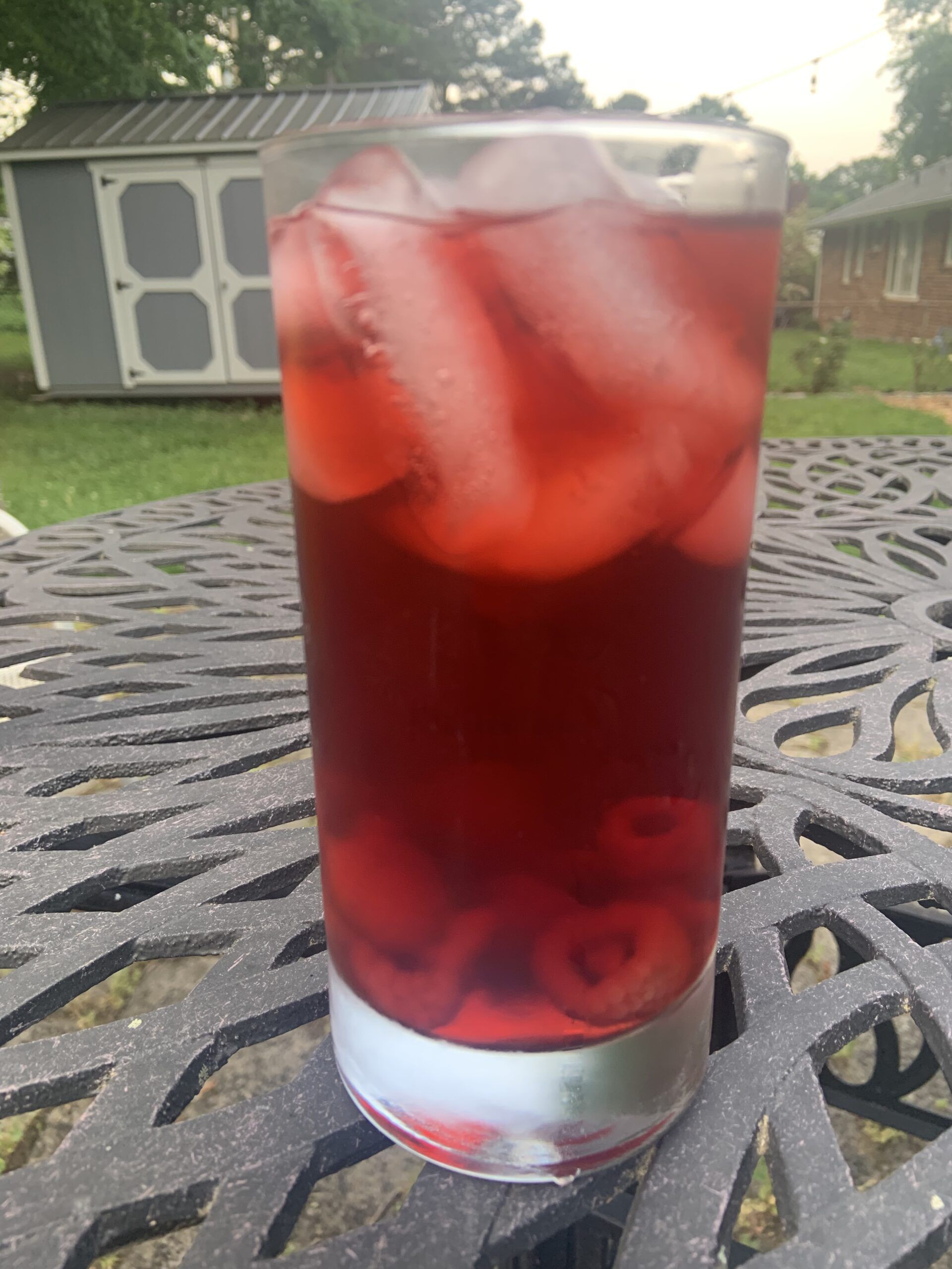 a photo of a glass of raspberry iced tea