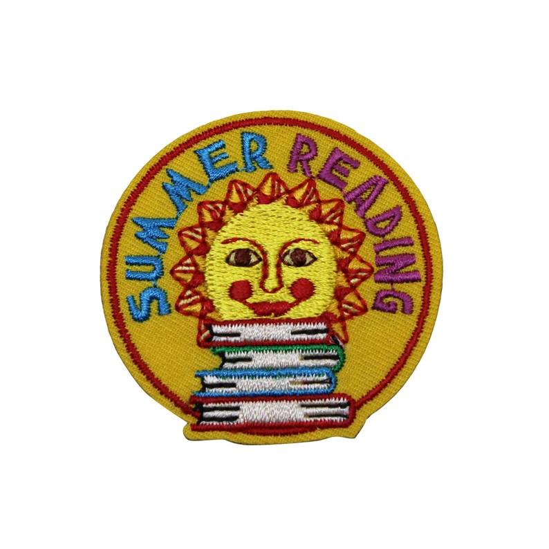 Image of an iron on patch. It is yellow with a big sun and a stack of books. It says "summer reading."