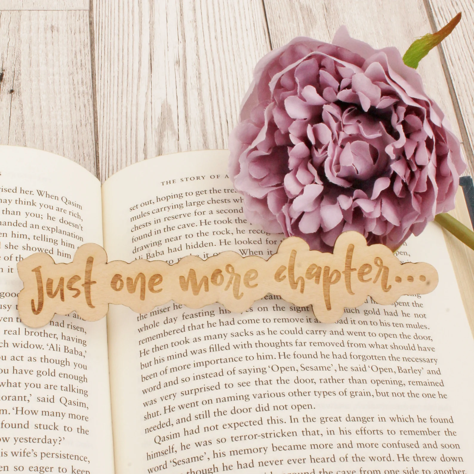 a wooden bookmark that reads "just one more chapter"
