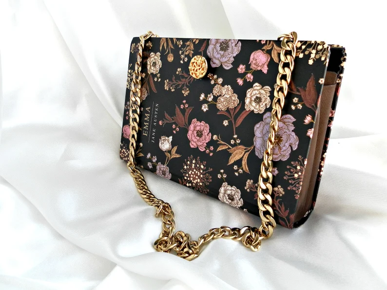photo of a black clutch with the cover of the book Emma
