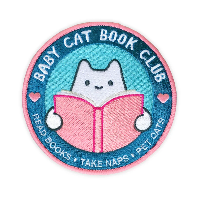 image of a white cat inside a pink and blue circle. It says "baby cat book club: read books, take naps, pet cats."