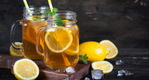 a photo of mason jars of iced tea with lemons beside them