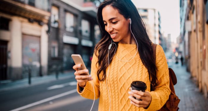 image of a Black person reading on their phone