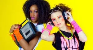 Image of two people dressed from the 1980s