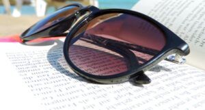 image of sunglasses on top of an open book