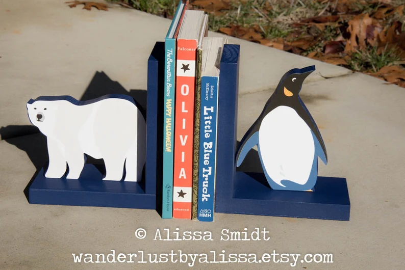 Image of a pair of bookends with a polar bear on one side and a penguin on the other. 