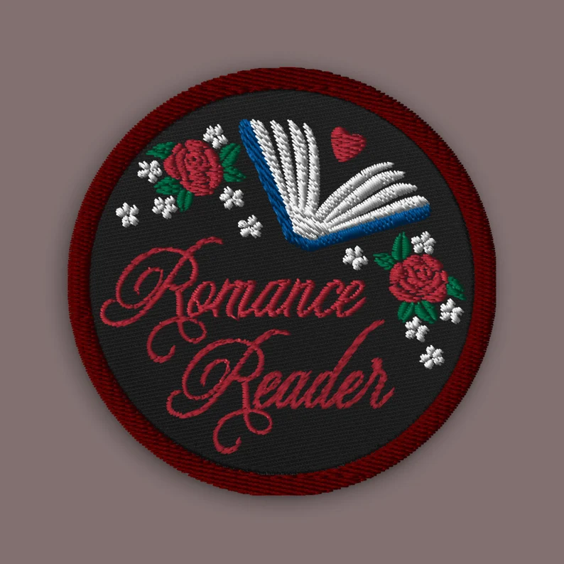 Image of a round patch that says "romance reader."