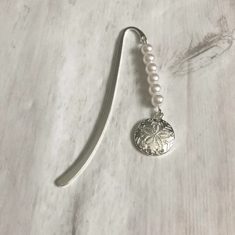 Image of a book mark with fake pearls and a metal sand dollar