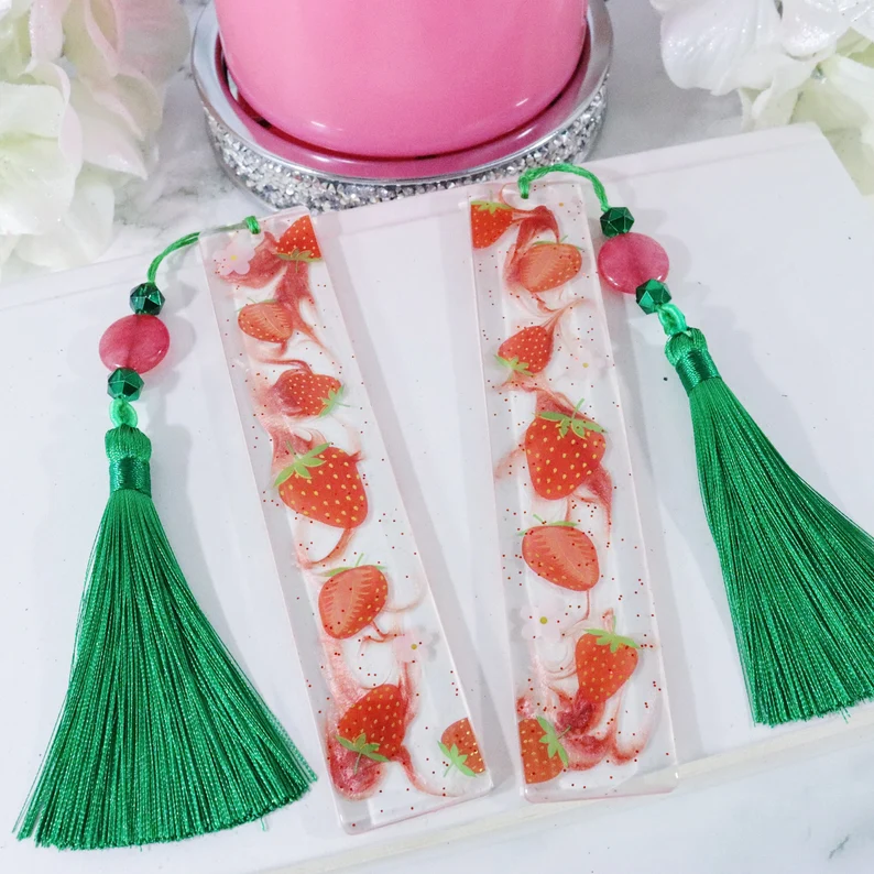 Image of a strawberry bookmark made of resin. 