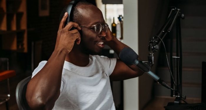 brown-skinned Black man with recording equipment