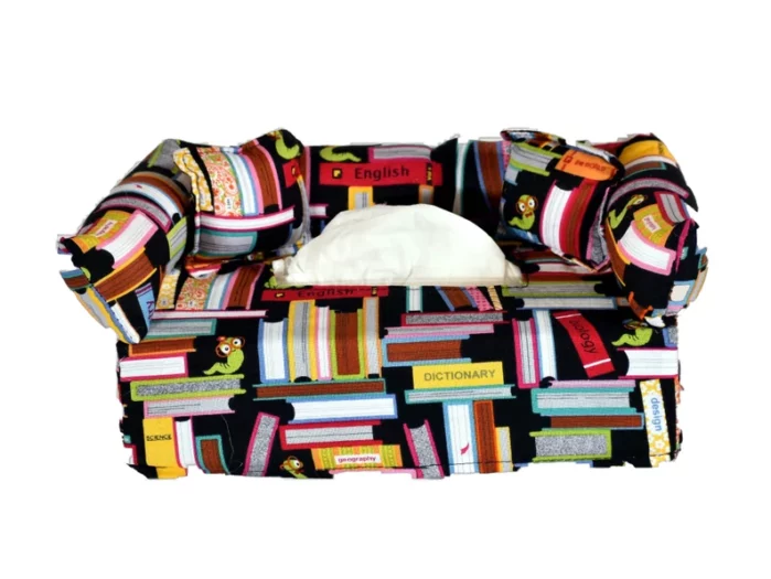 Couch shaped tissue holder made from fabrics with books on it