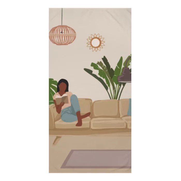 Beach towel with a living room scene in which a Black woman reads on the couch.