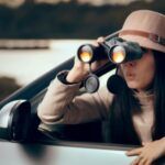 Female Detective Spying with Binocular from a Car