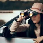 Female Detective Spying with Binocular from a Car