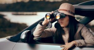 Female Detective Spying with Binocular from a Car