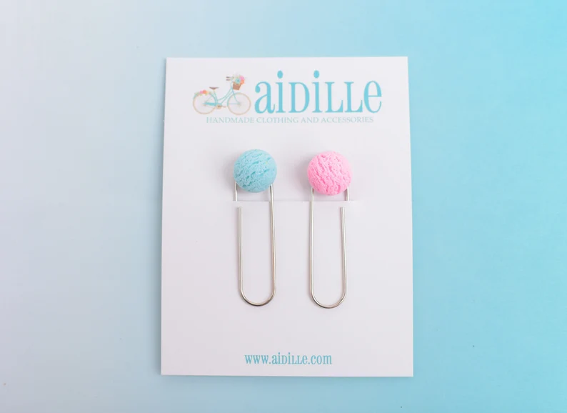 Image of two paperclip bookmarks. One has a blue scoop of ice cream and the other has a pink scoop. 