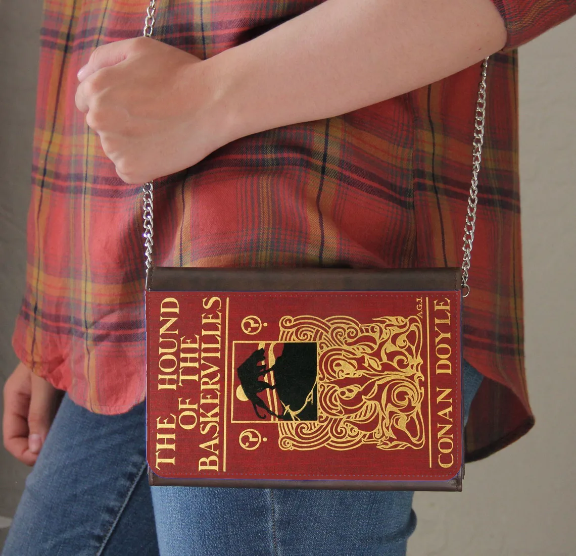 photo of a red purse shaped like a book with the book title "Hound of the Baskervilles" on it