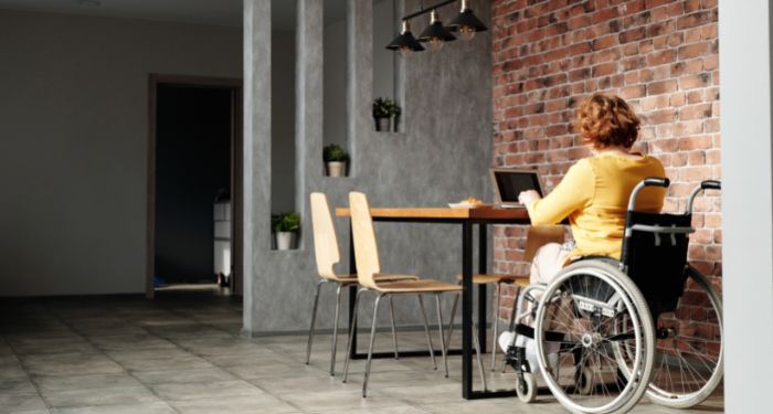 Image of a person in a wheel chair at a cafe