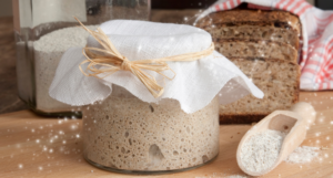 a photo of a sourdough starter and a loaf of bread with sparkles