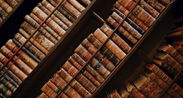 old books on shelves at an angle