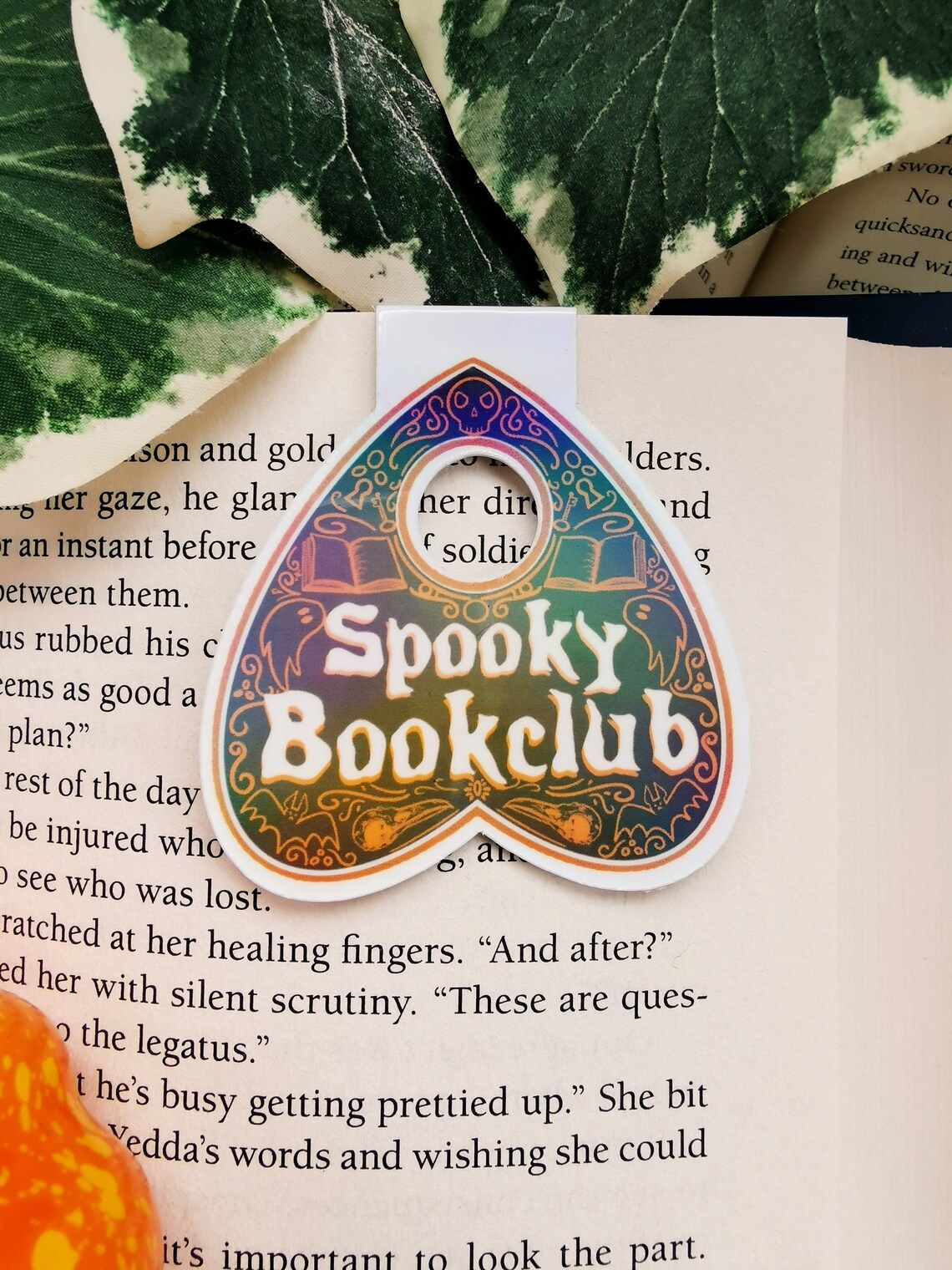 Image of a planchette bookmark with the words "spooky book club."