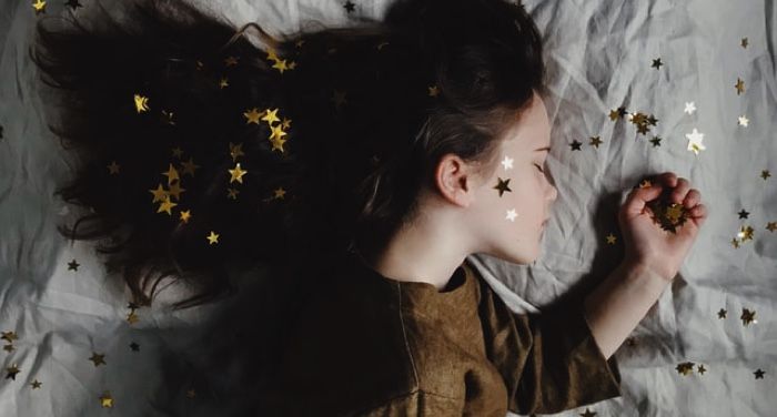 sleeping kid with gold stars in hair