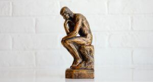 a photo of a small version of the Thinker statue