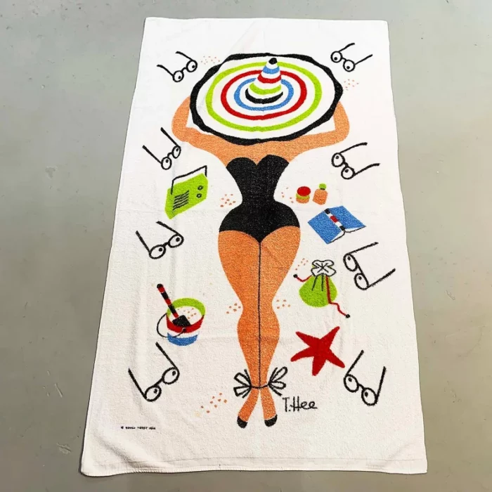 Vintage beach towel showing the back of a curvaceous person with books and eyeglasses strewn around.