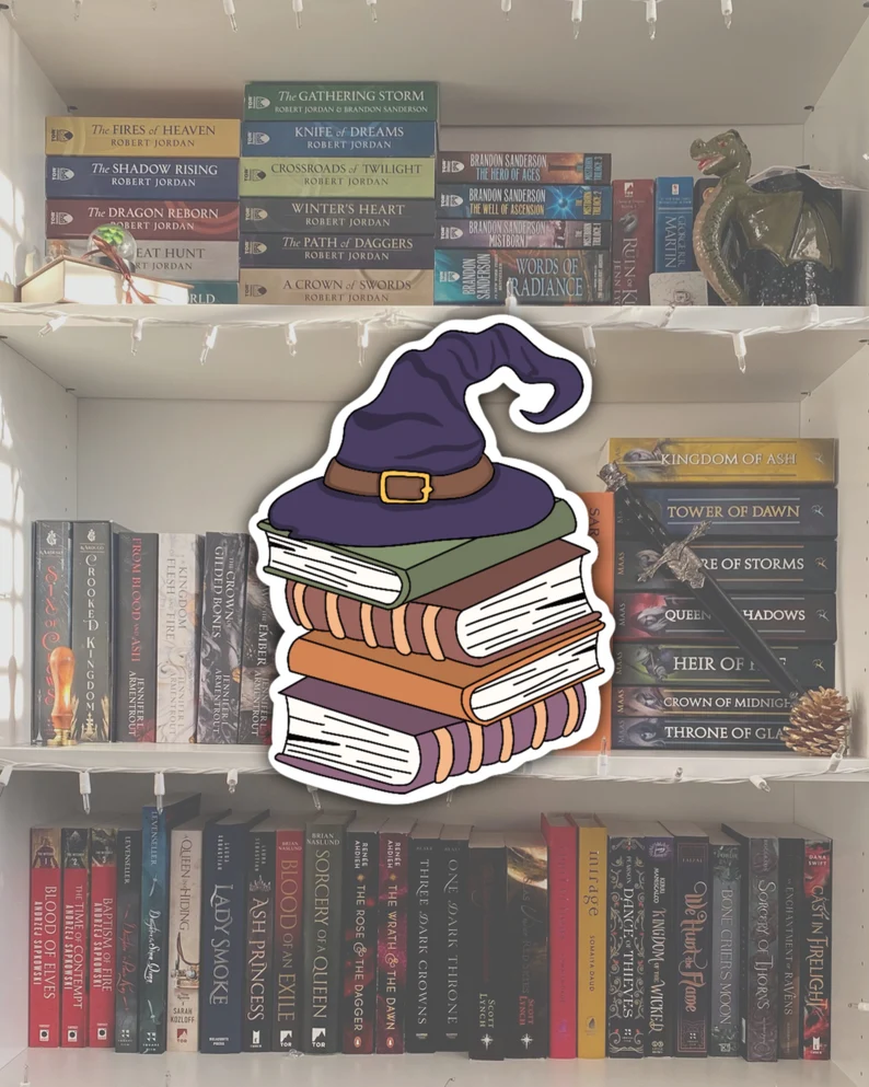 Image of a stack of books with a witch hat on top of them. 