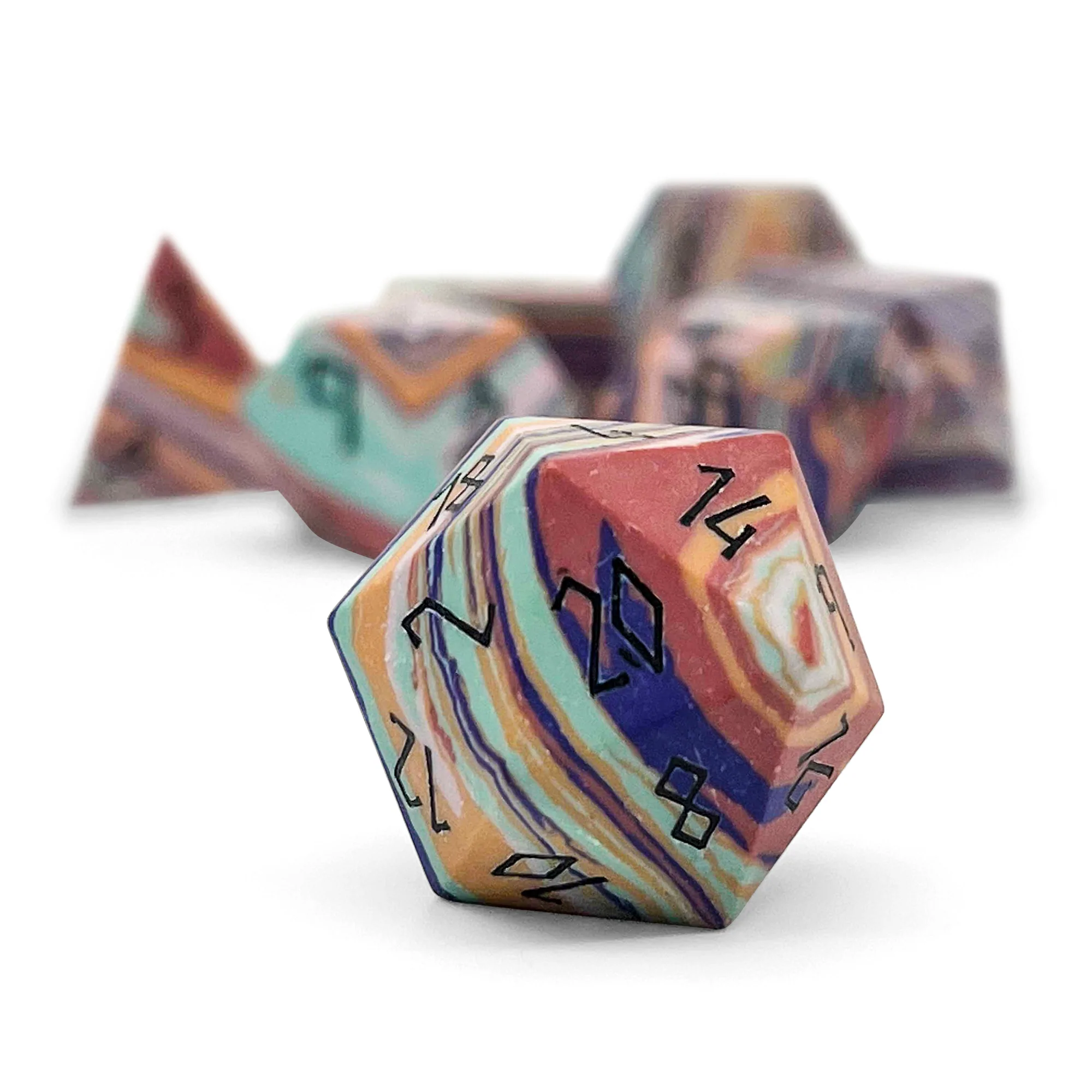 A photo of a set of seven banded rainbow turquoise dice with black numbers on the faces. 