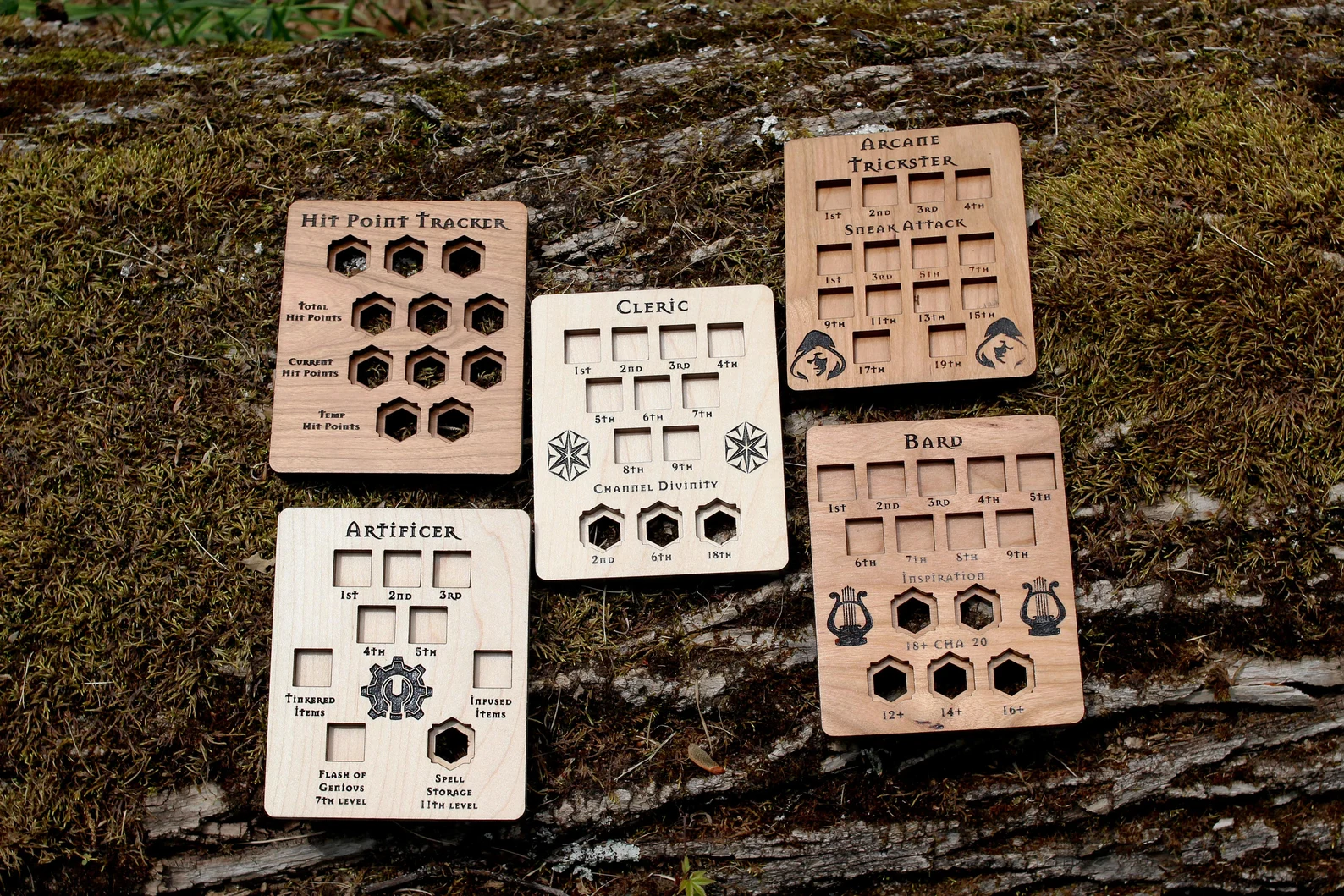 A photo of several wooden Spell and Ability Tracking Cards with wooden cavities and engraved labels for Dungeons and Dragons. 